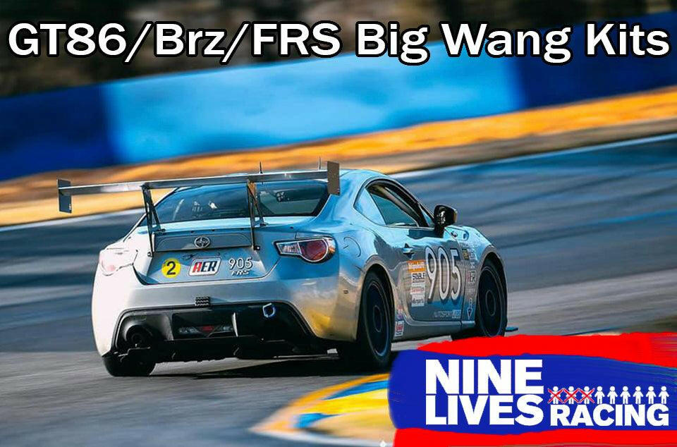 A silver racing car with the number 905 is speeding on a track. The text at the top reads "GT86 Big Wang Kit '12-'21 FRS / BRZ / 86," emphasizing Big Wang GT3 performance. The lower right corner shows a "9livesracing" logo in white and red text with a stylized row of people.