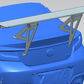 A digital rendering of a blue car's rear end displays a large, elevated rear wing spoiler from the 9livesracing GR86 / BRZ Wang Kit '22+. The sleek design features extruded aluminum wings with metallic mounting brackets, expertly positioned on the trunk lid to optimize performance airfoils. The car's license plate is not visible.