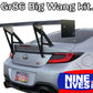 A silver Toyota GR86 is shown from the rear with a large aftermarket wing installed. The text "GR86 / BRZ Wang Kit '22+" is displayed at the top, and "9livesracing" appears at the bottom in a banner with a blue and red color scheme. Featuring extruded aluminum wings, it's designed for an optimal lift-to-drag ratio. The license plate reads "POORSH".